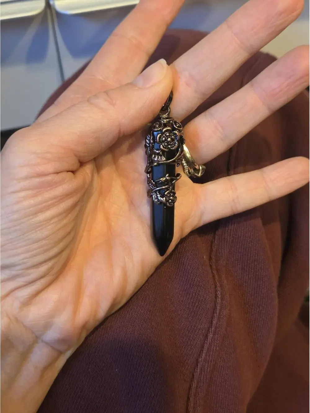 Black Point Pendant with Ornate Silver-Tone Floral Detail